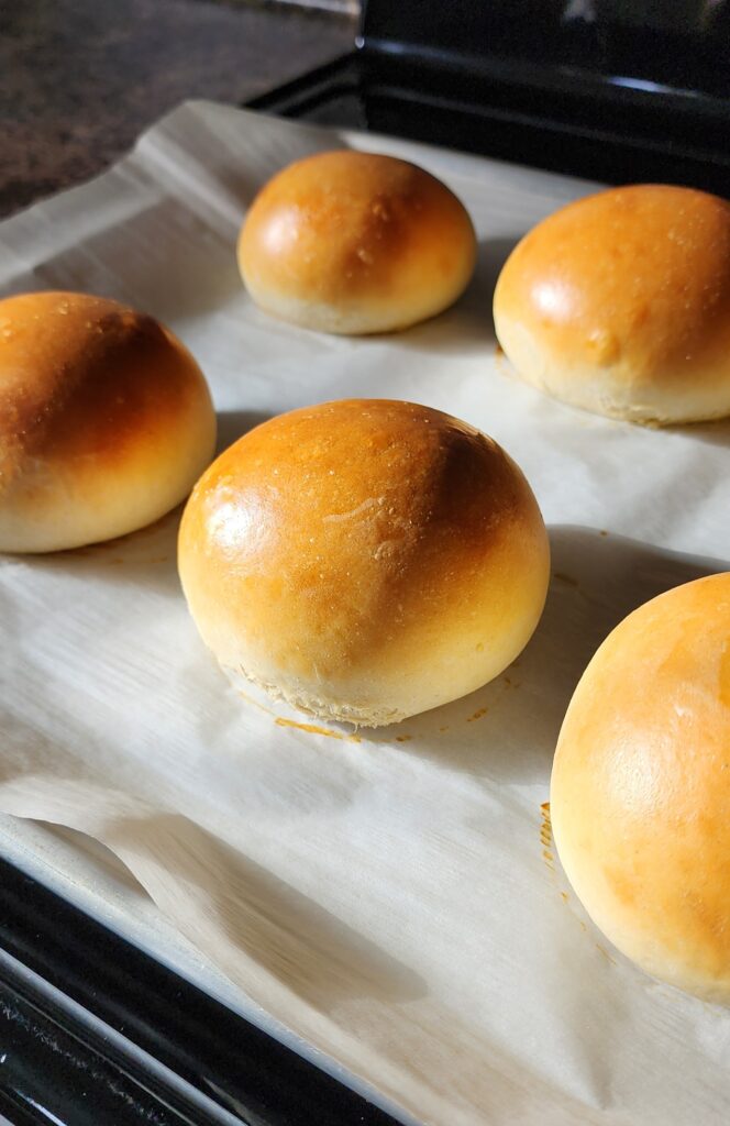 Burger buns on pan after baking.